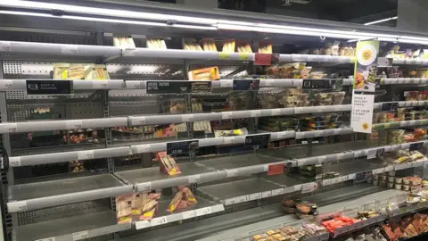 PA Media Empty shelves at Belfast Marks and Spencer on Monday