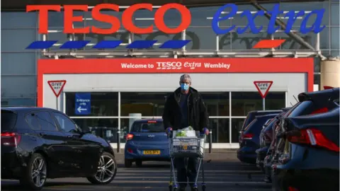 Getty Images A shopper outside Tesco