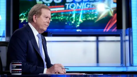 Getty Images Fox anchor Lou Dobbs in the studio of his TV programme on 23 September 2019
