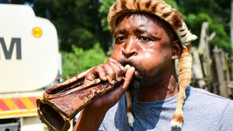 Getty Images Zulu Warriors at the funeral service of King Goodwill Zwelithini KaBhekuzulu on March 18, 2021 in Nongoma, South Africa.