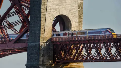 PA Media Hitachi Class 800 train crosses the Forth Bridge in Edinburgh
