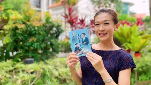 BBC Singaporean TV fan Kit Ow holding Oshin DVD