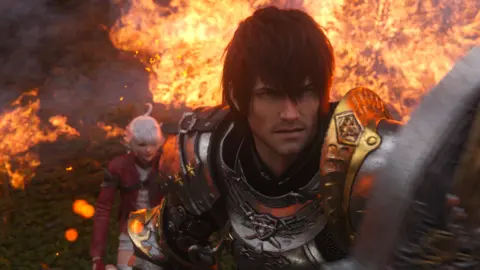 Square Enix The hero of FFIX stands with shield raised, protecting another character, amid flames