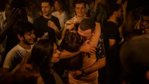 Getty Images Two people hug in the middle of the dance floor at Egg London nightclub (file image)