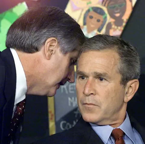 Getty Images Andy Card utters four words in the president's ear