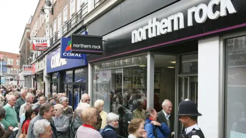 PA Media Customers queue outside a Northern Rock branch, 17 September 2007