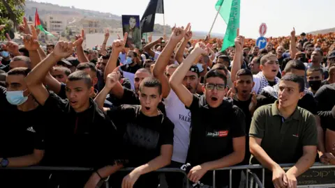 Reuters Israeli Arabs chant slogans during a protest against a wave of violent crime in their communities, in the town of Umm el Fahm, northern Israel (22 October 2021)