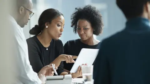 Getty Images Co-workers holding a meeting
