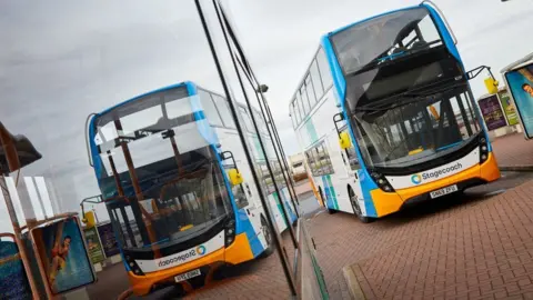 Stagecoach Double decker Stagecoach bus reflected at bus stop