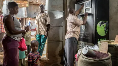 Jeroen van Loon Jackson Opati with the Zaidi Technologies milk ATM in his shop in Kibera, Nairobi