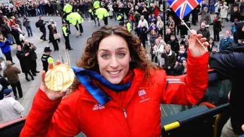 Amy Williams holding her gold medal