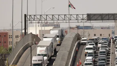 Getty Images Trucks queue at the US-Mexico border