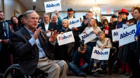 Brandon Bell Texas Governor Greg Abbott surrounded by supporters