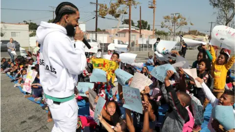 Getty Images Hussle speaking to children in LA