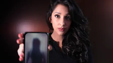 BBC Panorama reporter Monika Plaha holding a photo with a blurred image of a woman