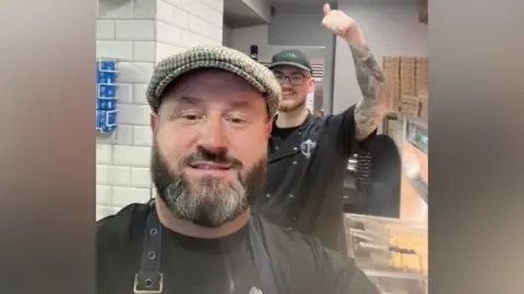 family photo Headteacher Lee Humphreys dons his apron on the weekends to work in his chip shop