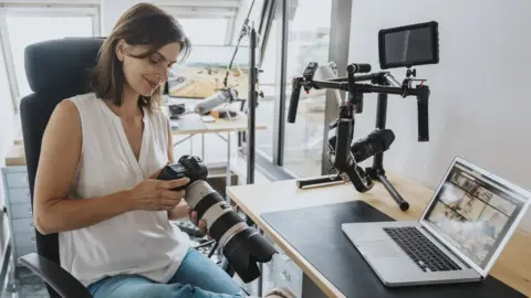 Getty Images A stock image of a professional photographer reviewing pictures