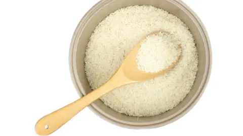 Getty Images Pot of rice with a wooden spoon