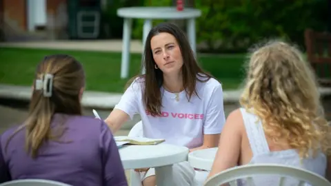 BOLD VOICES Natasha Eeles speaking to two girls at a workshop