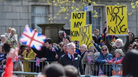 EPA Anti-monarchy protesters hold placards during the visit by Britain's King Charles III and Camilla Queen Consort to Liverpool Central Library, in Liverpool