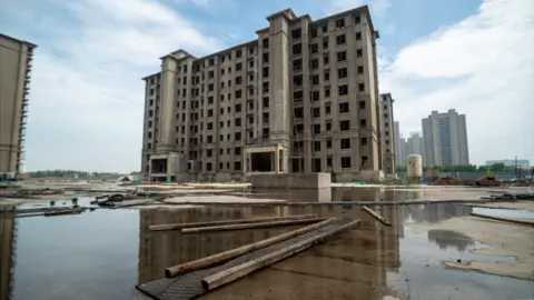 Joyce Liu/BBC An unfinished residential tower block in China
