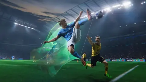EA A computer-generated version of Erling Haaland, in Manchester City's sky blue home strip, leaps for the ball in the middle of a match in EA Sports FC 24. He's in mid-air, in a karate kick-style pose and has one leg stretching out his orange football boot to make contact with the ball. A bright green vapour trail emanates behind him, showing the path he's followed. Another player is nearby and looks desperate as he tries to intercept Haaland.