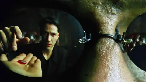 Alamy Keanu Reeves choosing the red pill in The Matrix