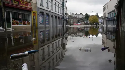 PA Media Debris and food water in Sugar Island in Newry city centre