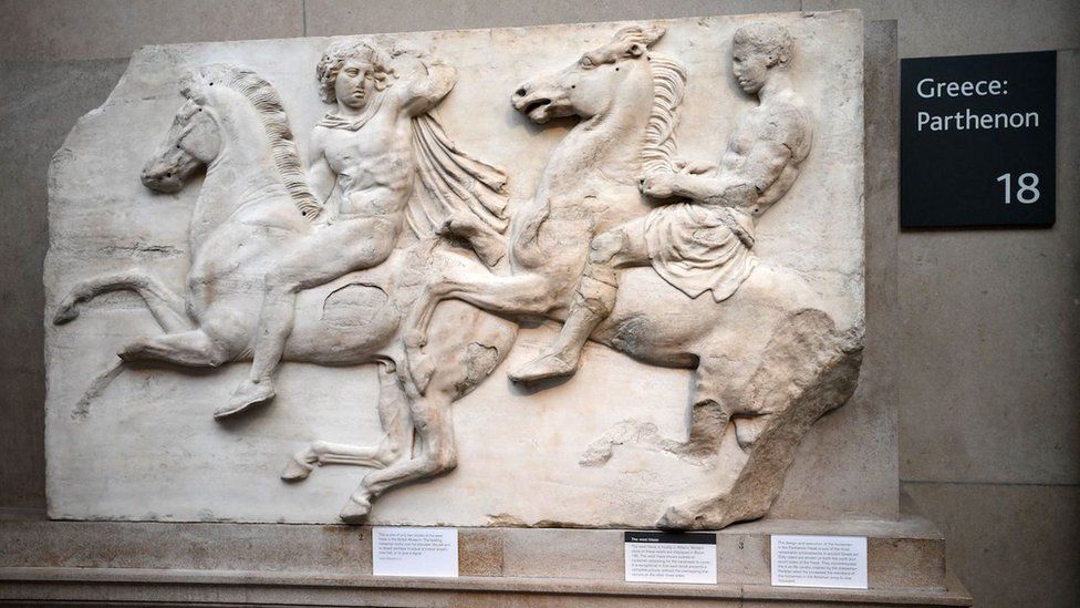 Relief sculpture of two men on horses