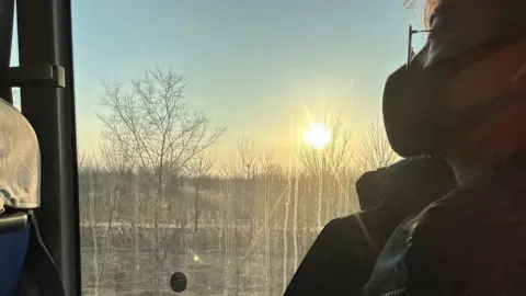 Handout Yuwen looks out of the window during a journey on public transport