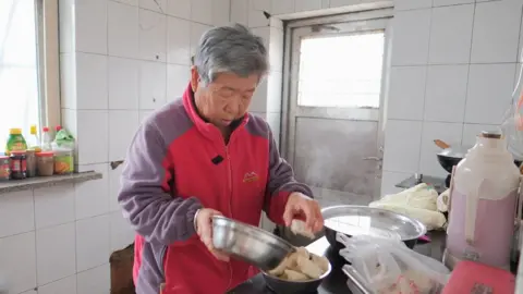 Xiqing Wang/ BBC Mr Cao's wife