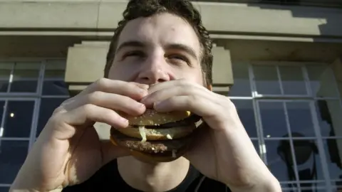 BBC a man eats a burger