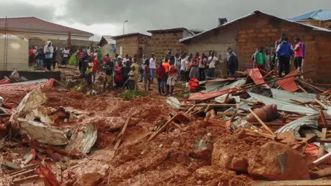 EPA Sierra Leone residents of Freetown view damage to property due to a mudslide in the suburb of Regent behind Guma reservoir, Freetown, Sierra Leone, 14 August 2017