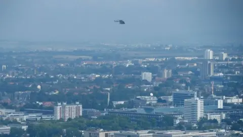 Reuters A police helicopter observes the danger zone as about 65,000 people in Frankfurt evacuate part of the city while experts defuse an unexploded British World War Two bomb