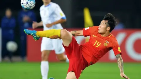 Getty Images China's Zhang Xizhe kicks the ball during the World Cup football qualifying match between China and Uzbekistan in Wuhan in China's central Hubei province on August 31, 2017