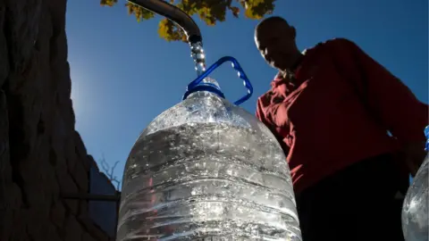 Getty Images Man filling flagon from tap
