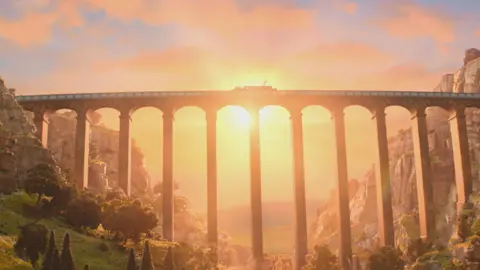 Aardman Animation An animated arched aqueduct spanning a wooded valley with steep rocky sides. There is a barge on the canal just visible and the scene is bathed in the orange pink light of a sunset. 