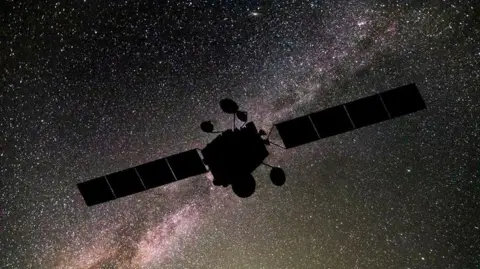 Getty Space object in the dark sky filled with stars. The object has two panels either side and a bulky box shape in the middle. 