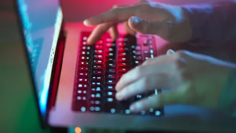 Getty Images Anonymous shot of a person's hand typing in a keyboard.