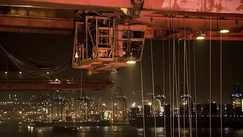 Giant cranes load ships in Hong Kong (Kate Davies/Unknown Fields)