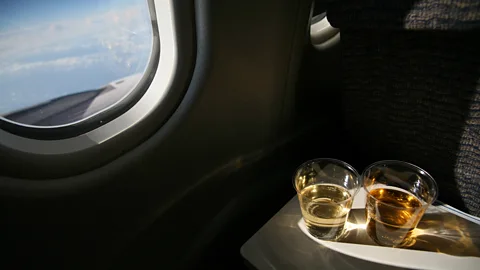 iStock Tests suggest the old adage that drinking at altitude while on aircraft flights increases the potency of alcohol is not actually true (Credit: iStock)