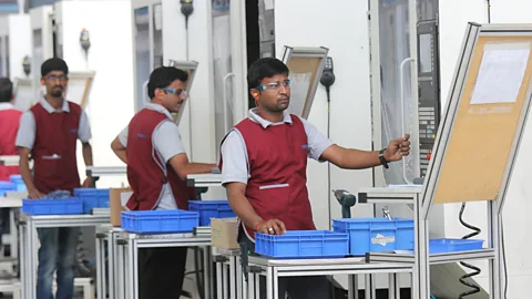 Alamy Stock Photo India is trying to future-proof job loss by acquainting students and workers to changing tech - workers are seen here in a Bangalore automation factory (Credit: Alamy Stock Photo)