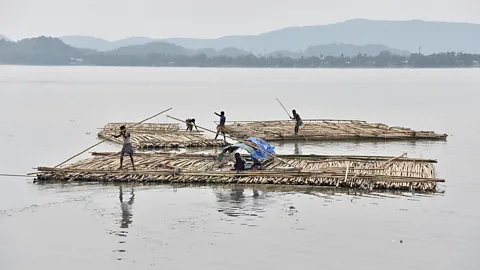 Getty Images The sapori people paddle rafts on the Brahmaputra River in South Kamrup, India (Credit: Getty Images)