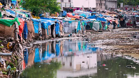 Alamy Without adequate drainage, standing water in Delhi's slums can become a breeding ground for disease (Credit: Alamy)