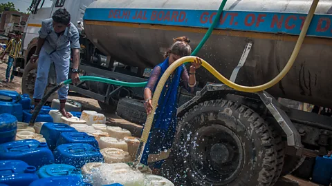 Getty Images Delhi's slums rely upon regular tankers to deliver water to the residents but shortages and disputes can interrupt the supply (Credit: Getty Images)