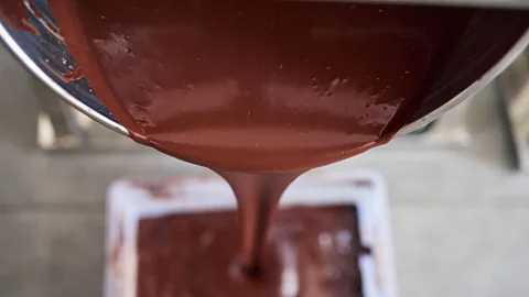 Mariusz Szczawinski/Alamy Liquid chocolate being poured into a mould