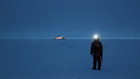 Martha Henriques An expedition member waits for a helicopter to arrive on the sea ice near Polarstern (Credit: Martha Henriques)