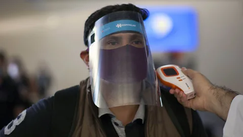 Julio Cesar Aguilar/Getty Images Remote infrared thermometers are already used in airports to detect fevers (Credit: Julio Cesar Aguilar/Getty Images)