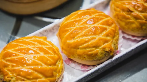 Kilito Chan/Getty Images The name "pineapple bun" comes from the pineapple-like pattern of the topping when baked (Credit: Kilito Chan/Getty Images)
