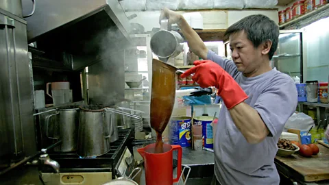 Reuters/Alamy Hong Kong-style milk tea is filtered through a long, stocking-like strainer (Credit: Reuters/Alamy)